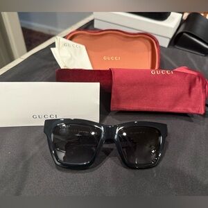Gucci GG1714S cat-eye sunglasses with a black frame and solid grey lenses
